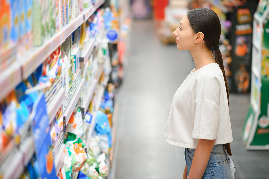 a young woman chooses household chemicals in a sup 2024 04 16 01 16 22 utc